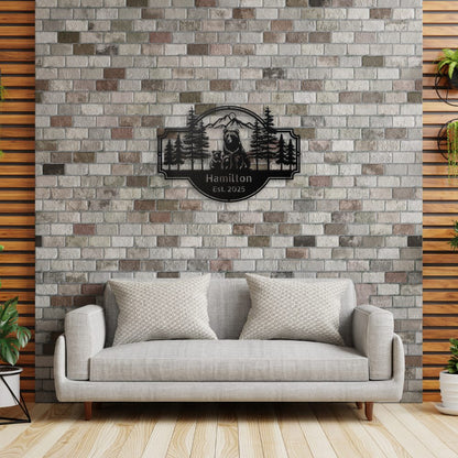 Personalized Bear Family Metal Sign – Custom Cabin & Family Name Wall Art in black against a brick feature wall in a contempory living room, with a tan sofa beneath the sign.