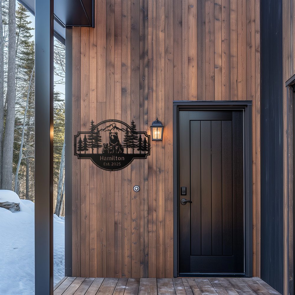 Personalized Bear Family Metal Sign – Custom Cabin & Family Name Wall Art in black hanging against a cedar plank wall of a modern cabin entryway porch.