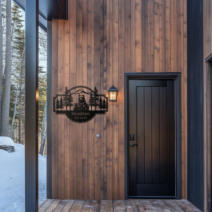 Personalized Bear Family Metal Sign – Custom Cabin & Family Name Wall Art in black hanging against a cedar plank wall of a modern cabin entryway porch.